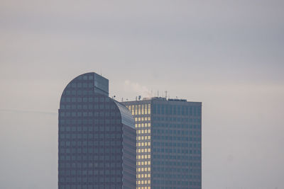 Skyscrapers in city against sky