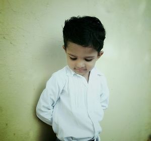 Boy standing against wall