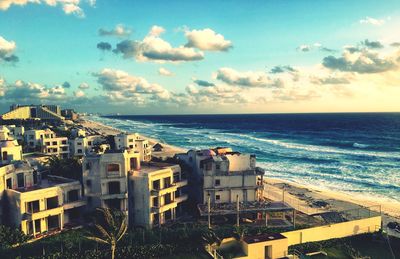 Buildings by sea against sky in city