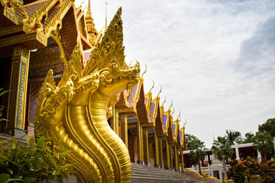 Statue of temple in building against sky