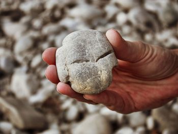 Close-up of hand holding stones