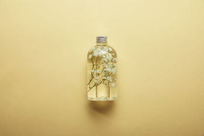 Close-up of bottle against yellow background