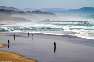 Scenic view of sea with mountain in background