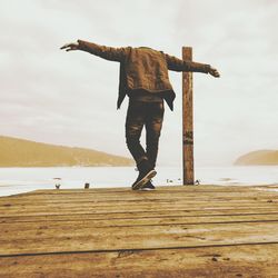 Full length of man standing on beach against sky
