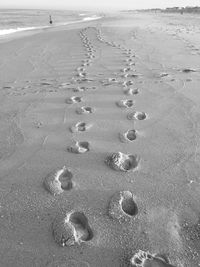 High angle view of footprints on beach