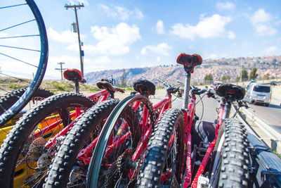 Close-up of bicycle parked against sky