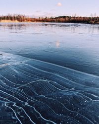 Surface level of frozen lake against sky