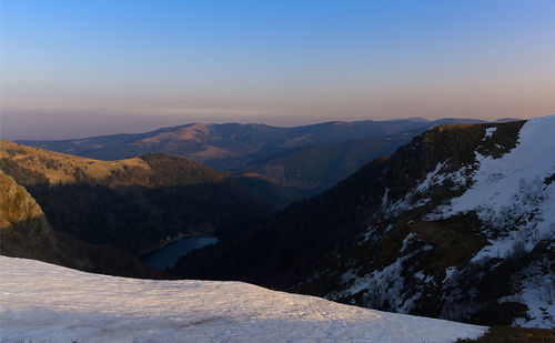 Scenic view of snowcapped mountains against clear sky