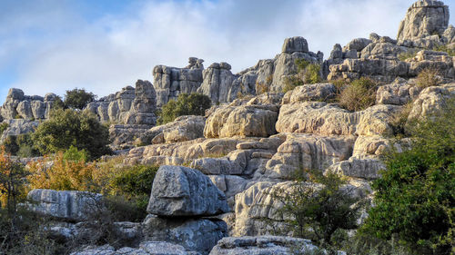 Panoramic view of rocks and trees against sky