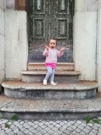 Full length of cute girl standing on staircase