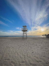 Lifeguard hut on beach against sky