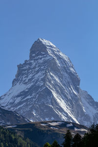 Scenic view of snowcapped mountains against clear blue sky