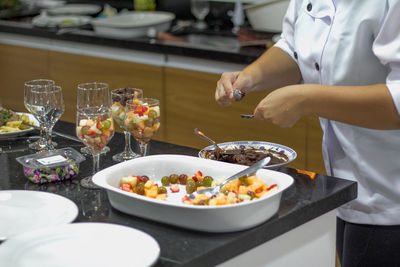 Woman holding ice cream served in plate
