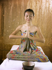 Young woman meditating in spa