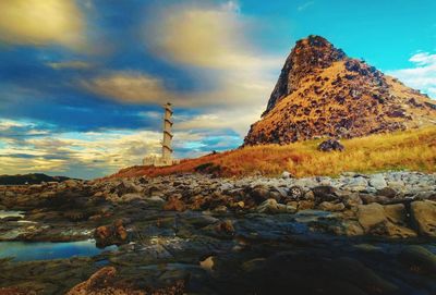 Low angle view of rock formation against sky