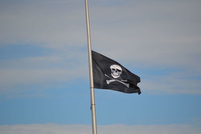 Low angle view of flag against sky