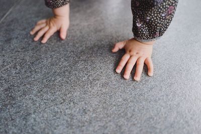 Cropped hands on floor at home