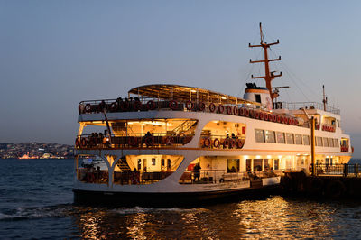 Illuminated ship in city at night