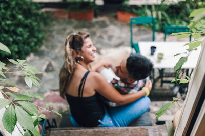 Affectionate couple sitting in backyard