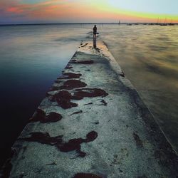 Scenic view of sea against sky at sunset