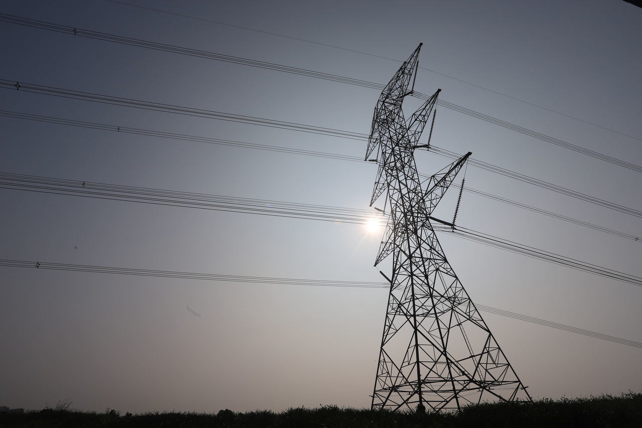 LOW ANGLE VIEW OF SILHOUETTE ELECTRICITY PYLON ON FIELD AGAINST SKY DURING SUNSET