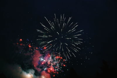 Low angle view of fireworks in sky at night