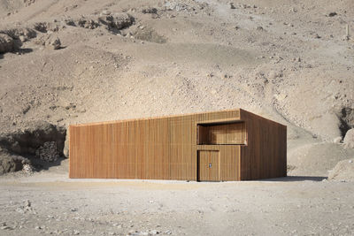 Exterior of geometric wooden house in desert environment