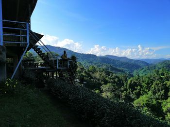 Scenic view of trees on mountains against sky