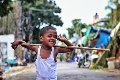 Portrait of happy boy with arms raised