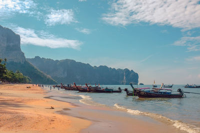 People on beach against sky