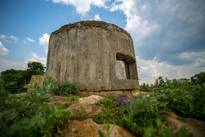 Low angle view of old castle on field against sky