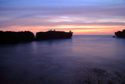 Scenic view of sea against romantic sky at sunset