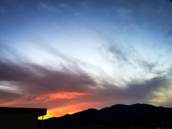 Silhouette landscape against sky during sunset