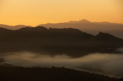 Scenic view of silhouette mountains against sky during sunset