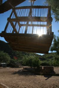 Low angle view of abandoned building against bright sun