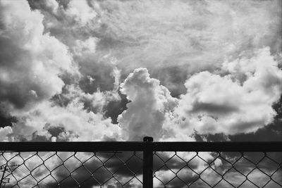 Low angle view of chainlink fence against sky