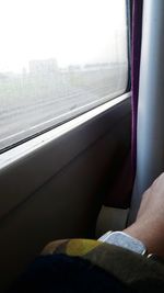 Close-up of person sitting in train