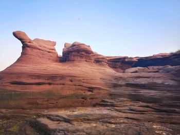 Rock formations on landscape against clear sky