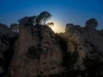 Low angle view of rock formation against sky