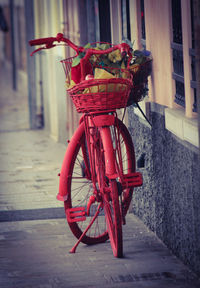 Red bicycle on footpath by street