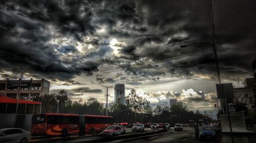 View of city street against cloudy sky