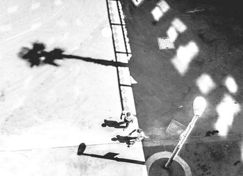 Shadow of people on road