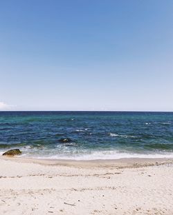 Scenic view of sea against clear blue sky