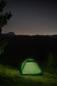 Tent on field against sky at night