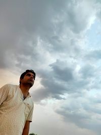 Low angle view of man standing against sky