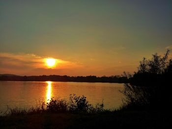 Scenic view of lake at sunset