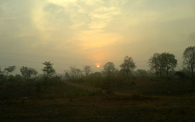 Scenic view of landscape against sky at sunset