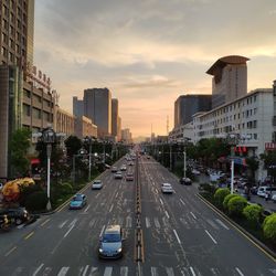 High angle view of vehicles on road in city against sky during sunset