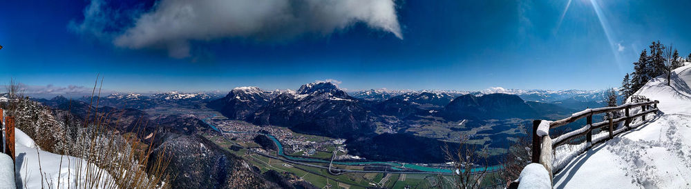 Panoramic view of snowcapped mountains against blue sky