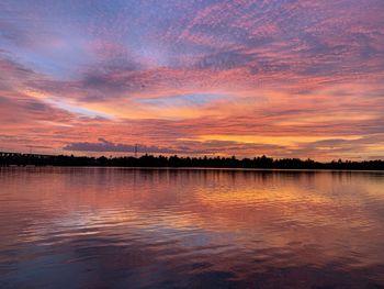 Scenic view of lake against romantic sky at sunset